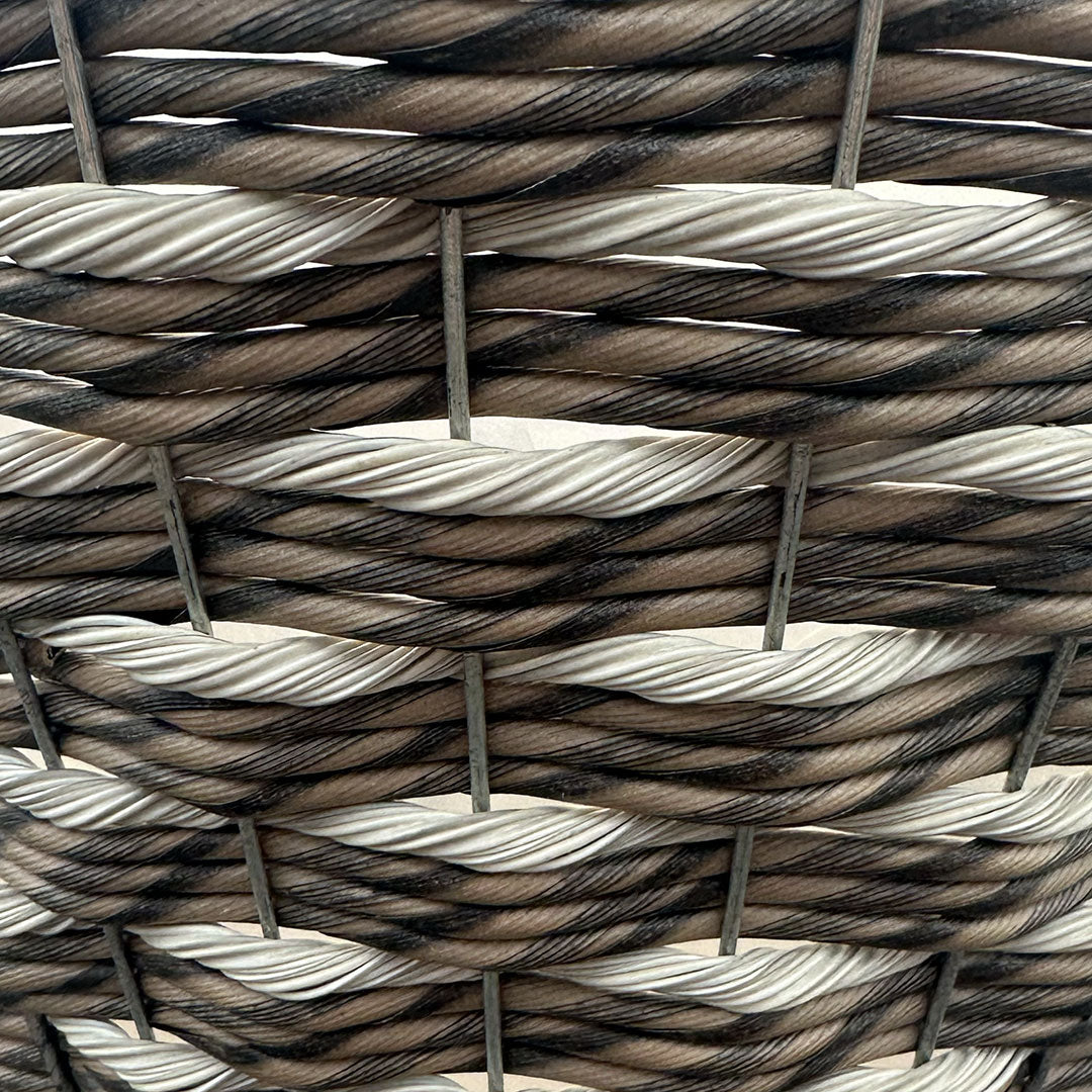 Closeup of basket with interwoven tan and brown mixed resin rope