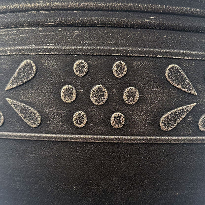 Close up of black pot with Brushed Champagne band pattern that is an abstract flower and leaf pattern